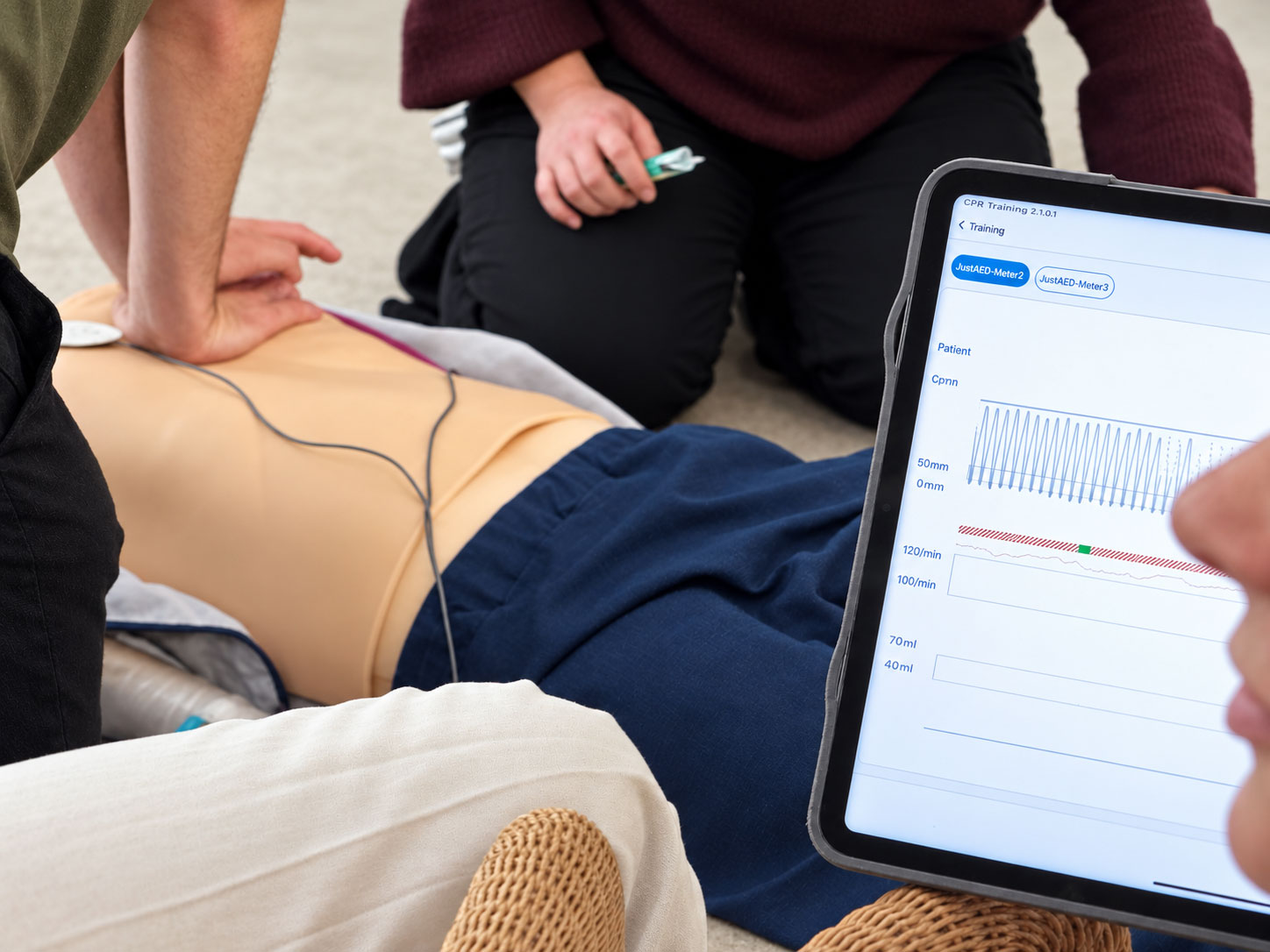 Tablet zeigt digitale Auswertung von Drucktiefe und Frequenz während der Herzdruckmassage